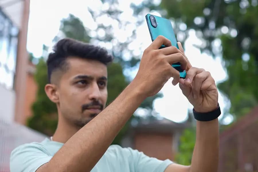 Boy holding samsung A07 in his hands.